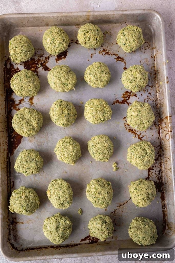 A spread of falafel, fresh herbs, and tahini sauce.