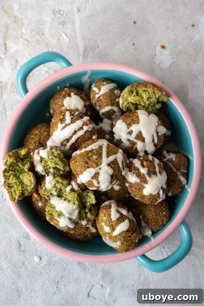 A selection of sauces and fresh ingredients accompanying falafel.