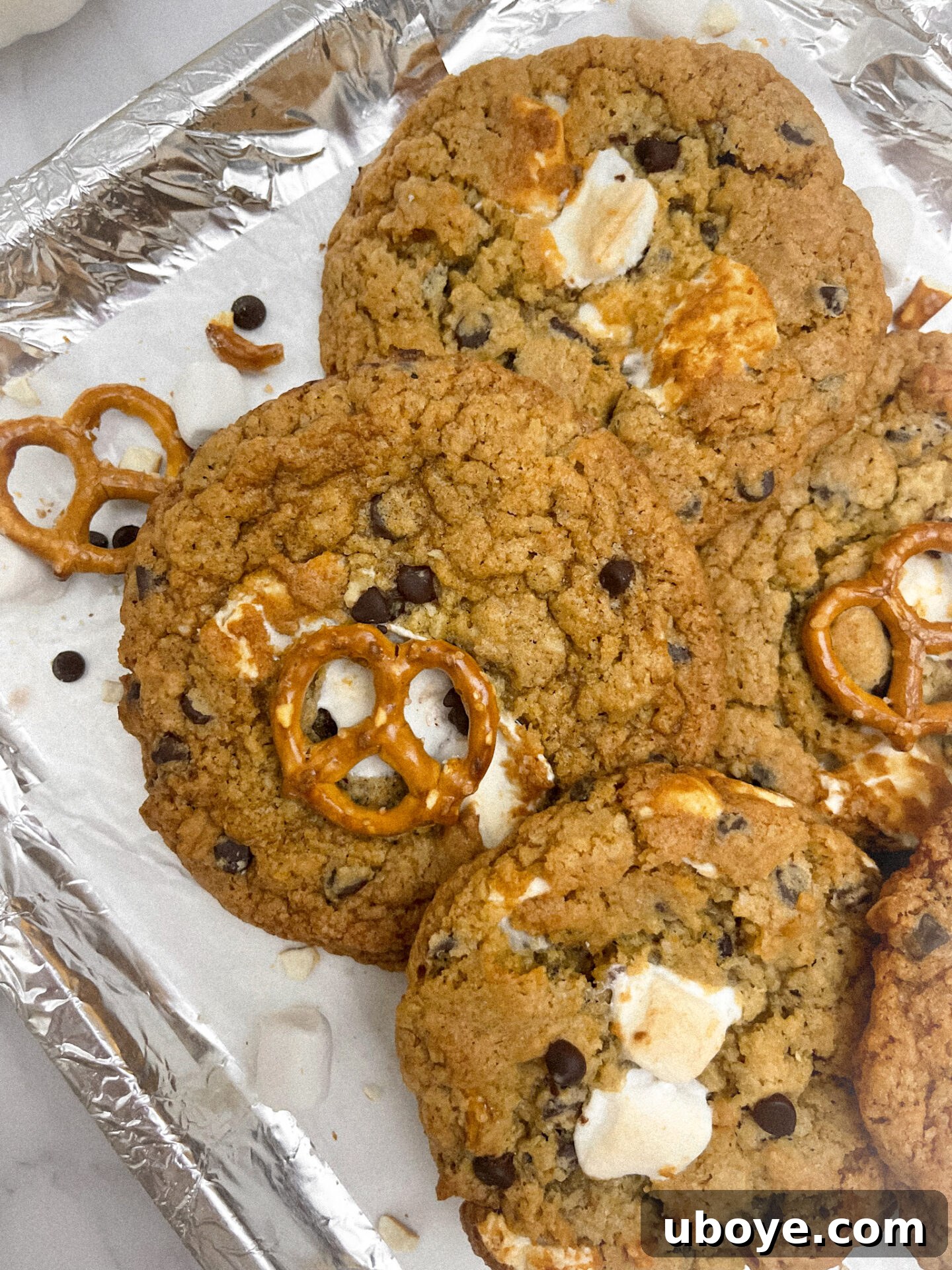 A stack of golden brown Vegan Pretzel S'mores Cookies on a cooling rack, highlighting their perfect texture.