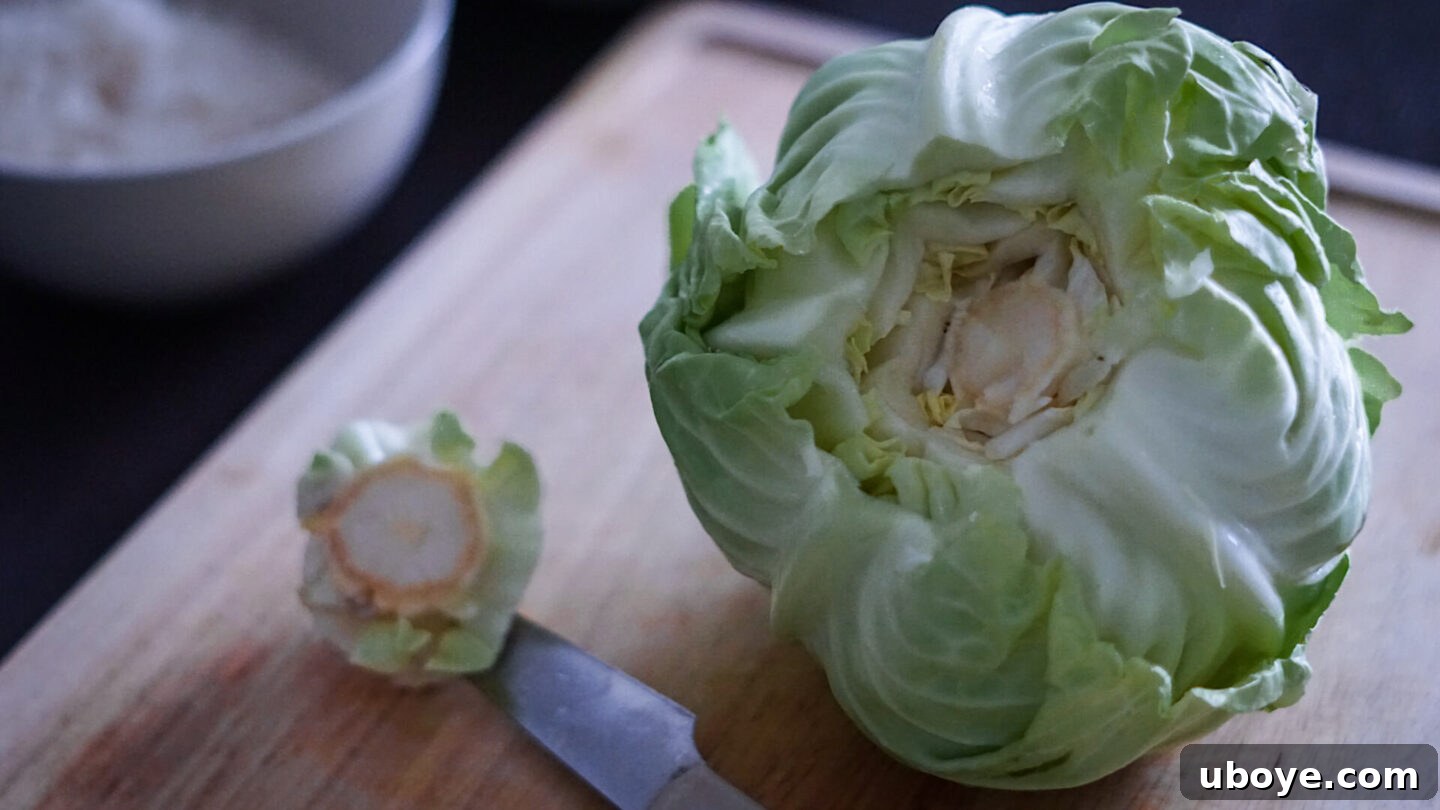 Hearty Plant-Based Cabbage Rolls 6 Image showing how to prepare cabbage leaves for rolling, including removing the core and trimming ribs.