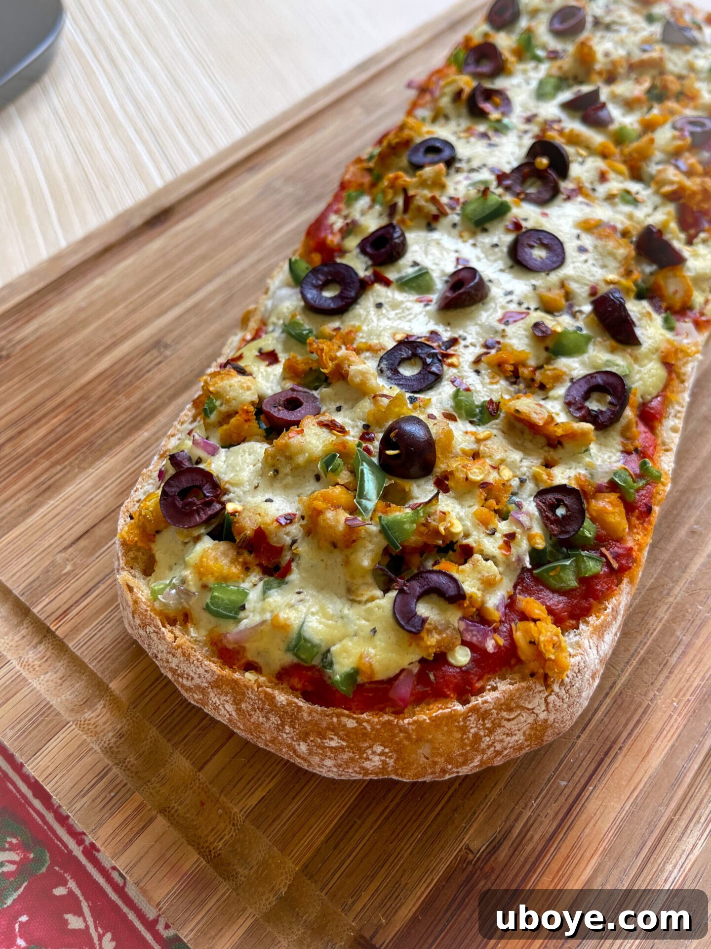 Close-up of Plant-Based French Bread Pizza with melted cheese and fresh herbs