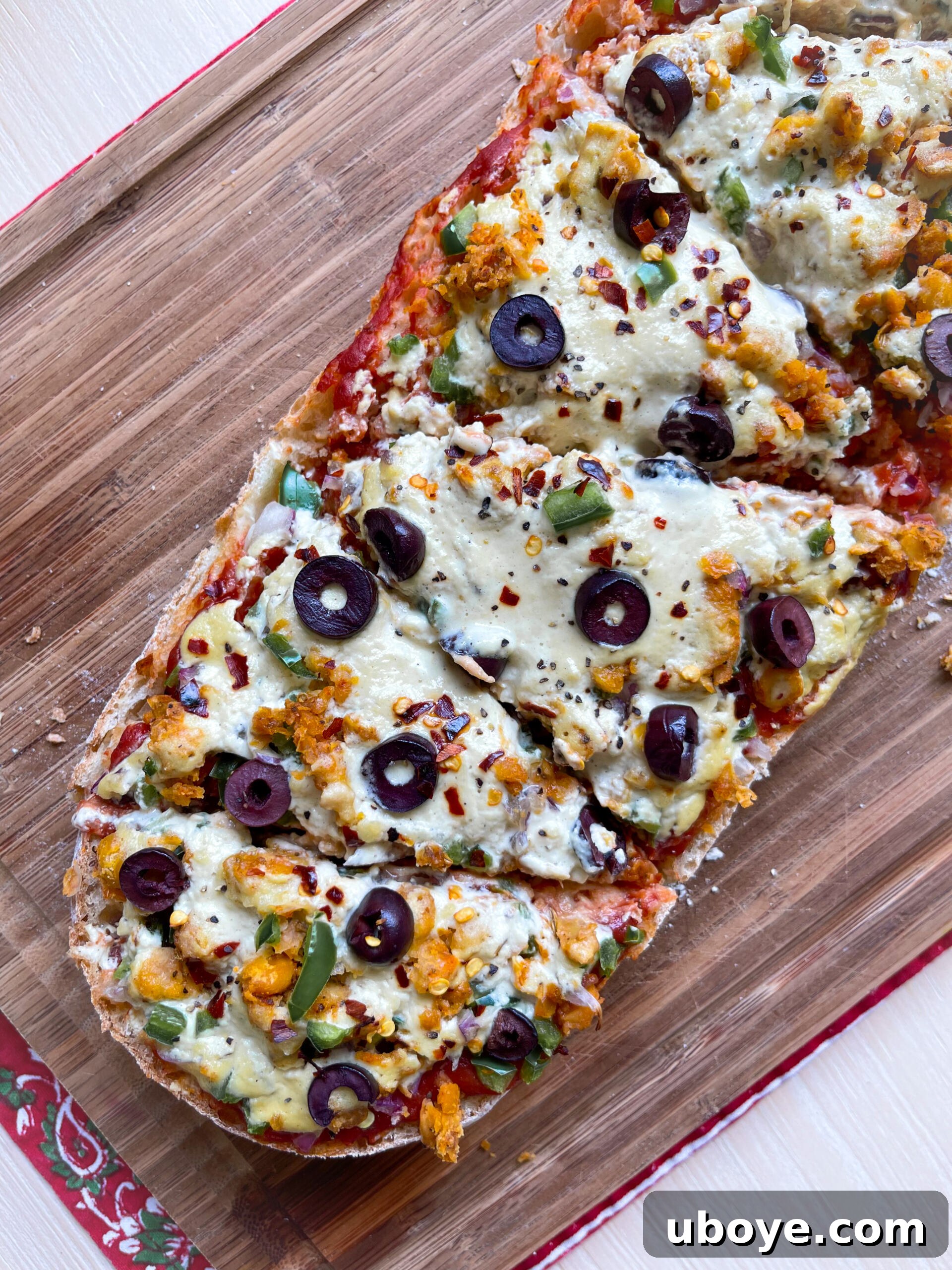 Three slices of Plant-Based French Bread Pizza on a wooden board