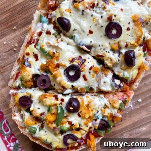 french bread pizza on a wooden cutting board