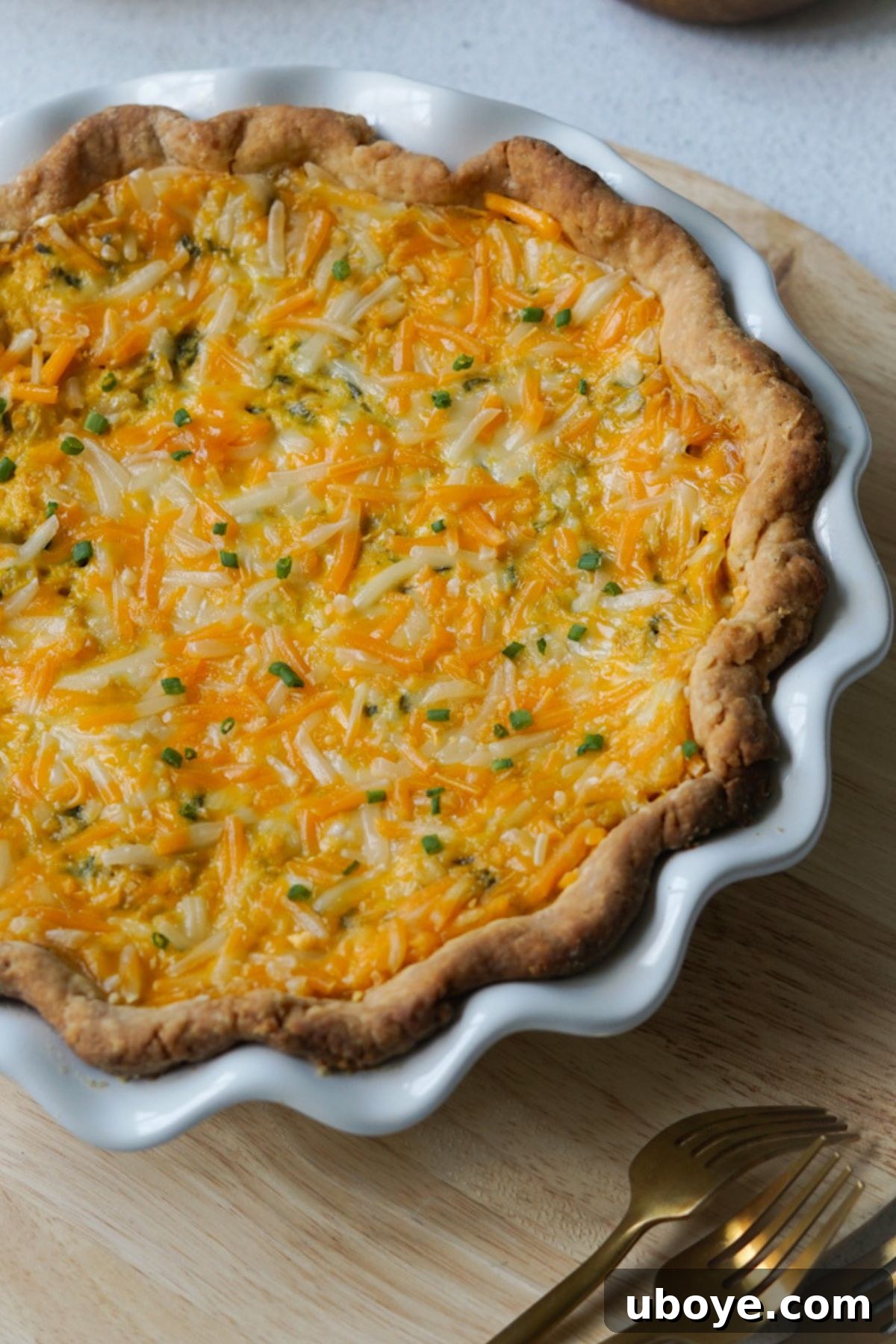 A slice of freshly baked vegan spinach quiche with a golden crust