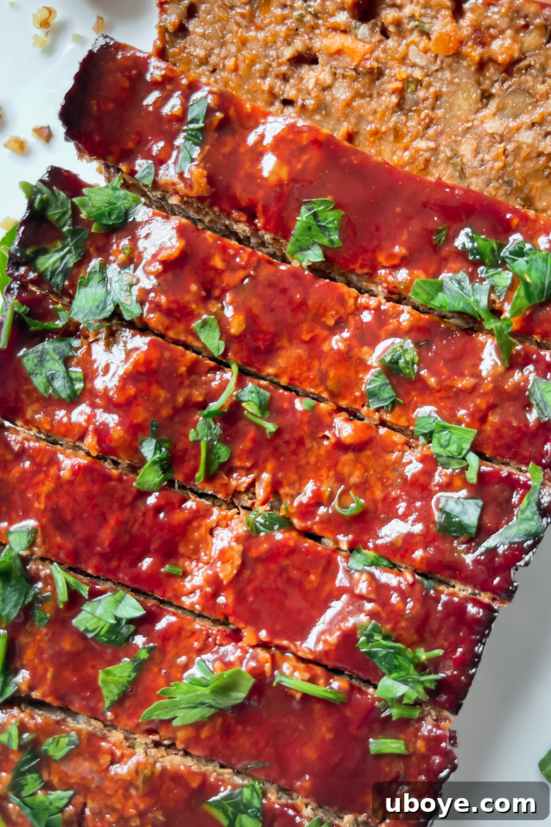Close-up of the lentil meatloaf, showing its rich, textured interior and crispy top.