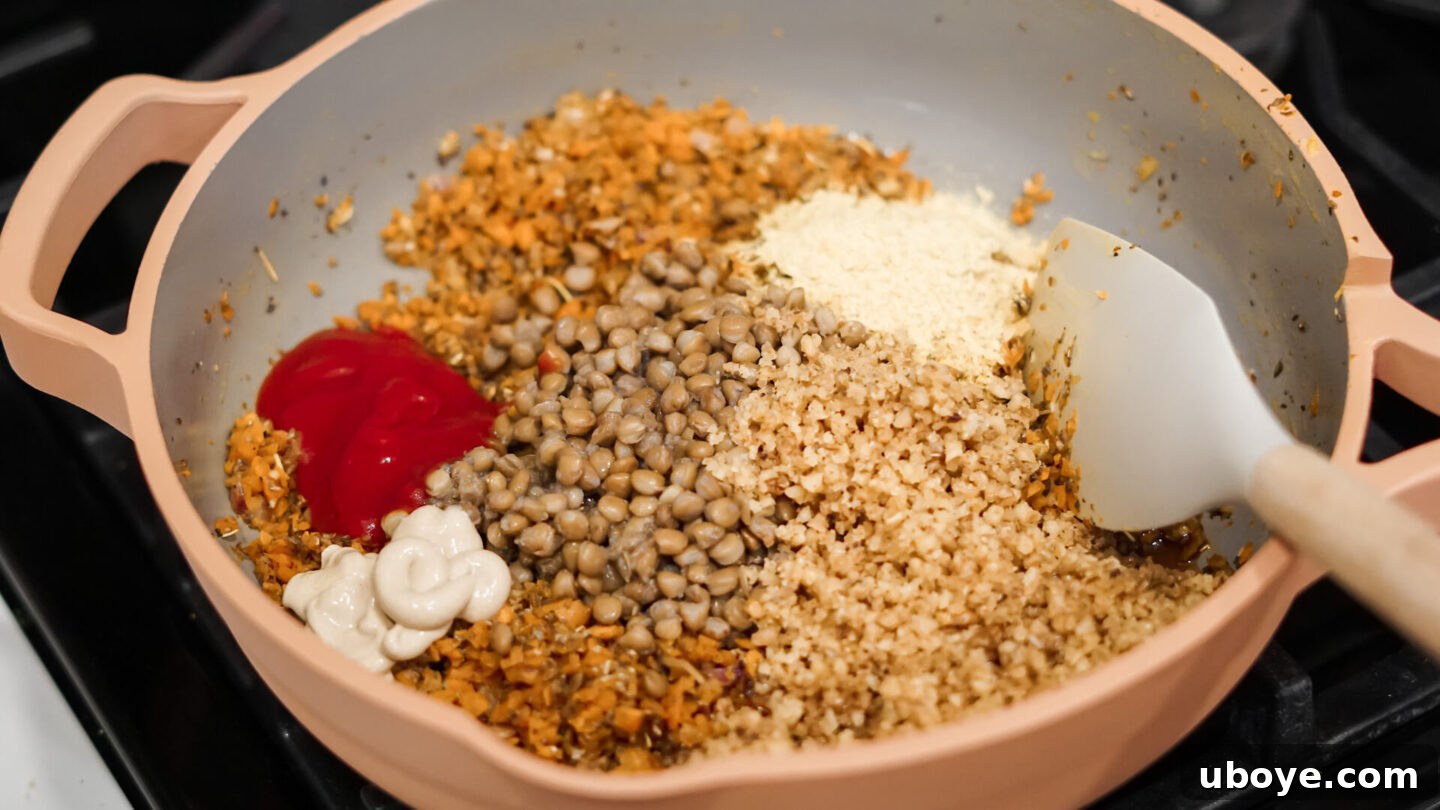 A pan with sautéed vegetables, lentils, and herbs, ready for mixing.