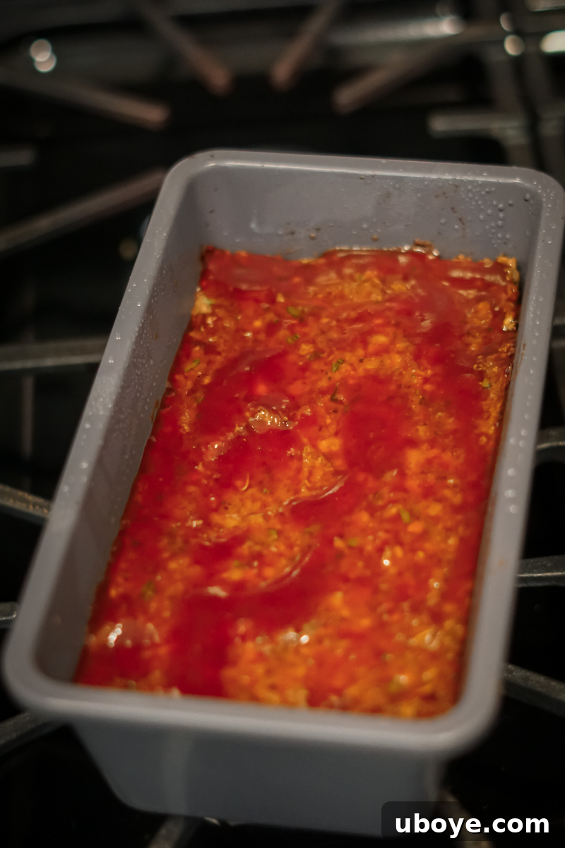 The lentil meatloaf mixture pressed into a loaf pan, ready for baking.