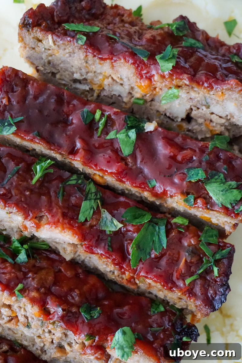 A freshly baked vegan meatloaf, perfectly glazed, cooling on a cutting board, ready to be sliced.