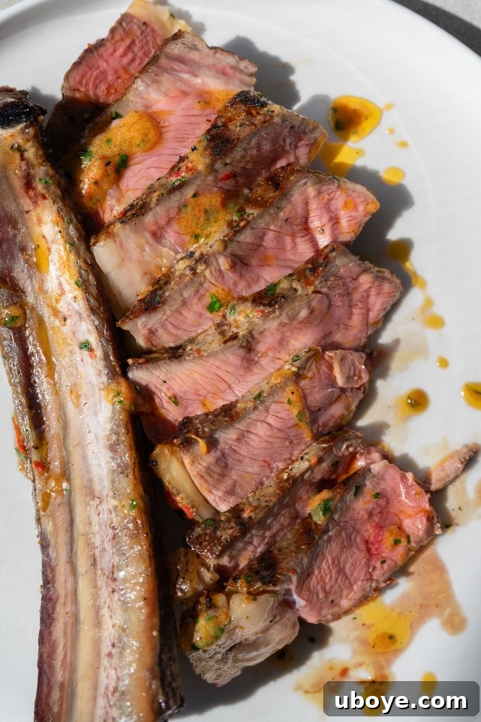 Hands seasoning a large ribeye steak for dry brining