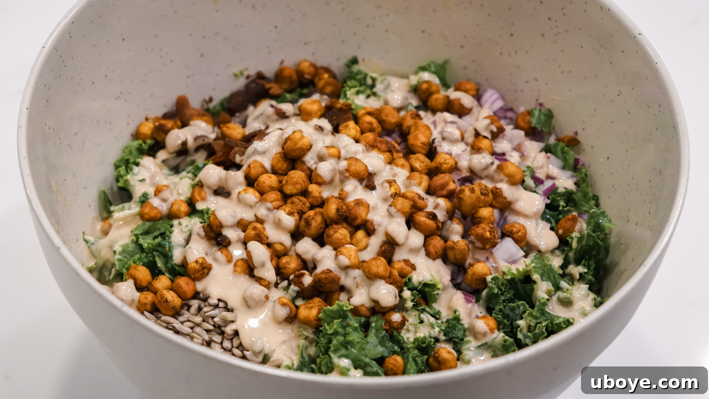 Finished crispy chickpea and kale salad with generous tahini dressing drizzle.
