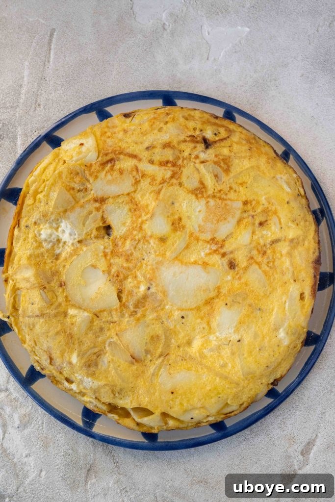 Authentic Spanish Tortilla 5 Sliced potatoes and onions frying in olive oil for Spanish Tortilla.