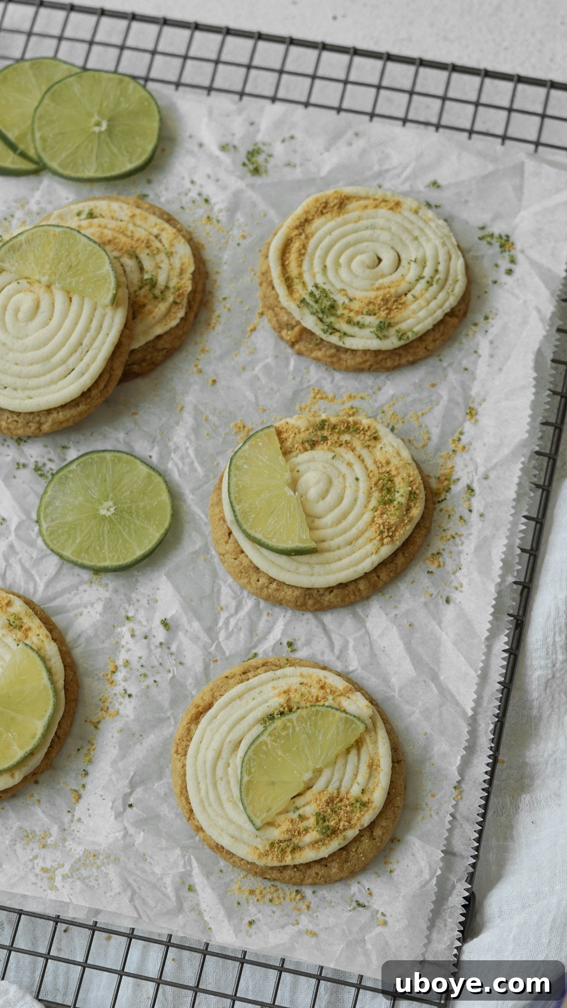 A stack of Key Lime Pie Cheesecake Cookies garnished with lime zest