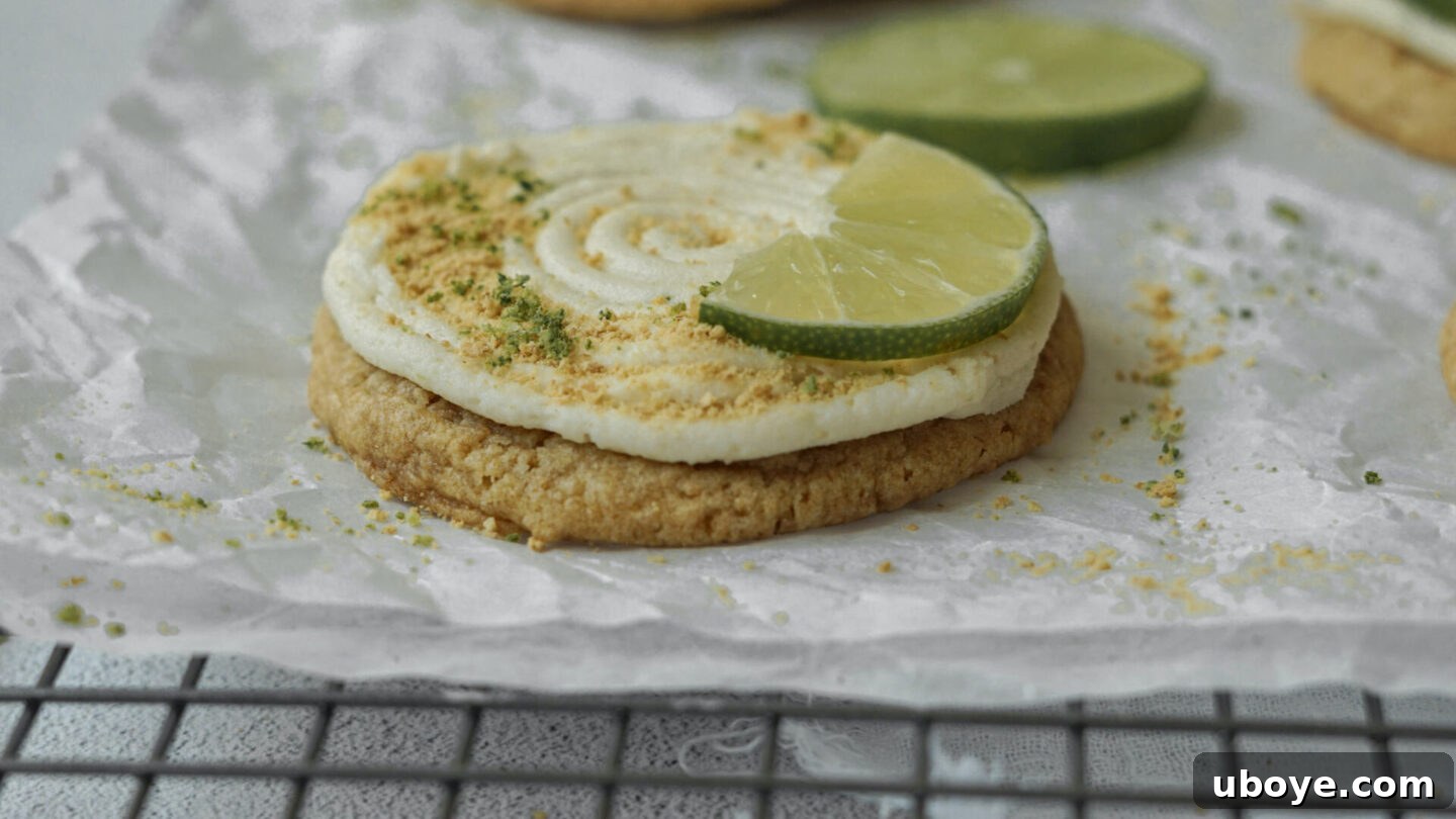 A freshly frosted Key Lime Pie Cheesecake Cookie on a cooling rack