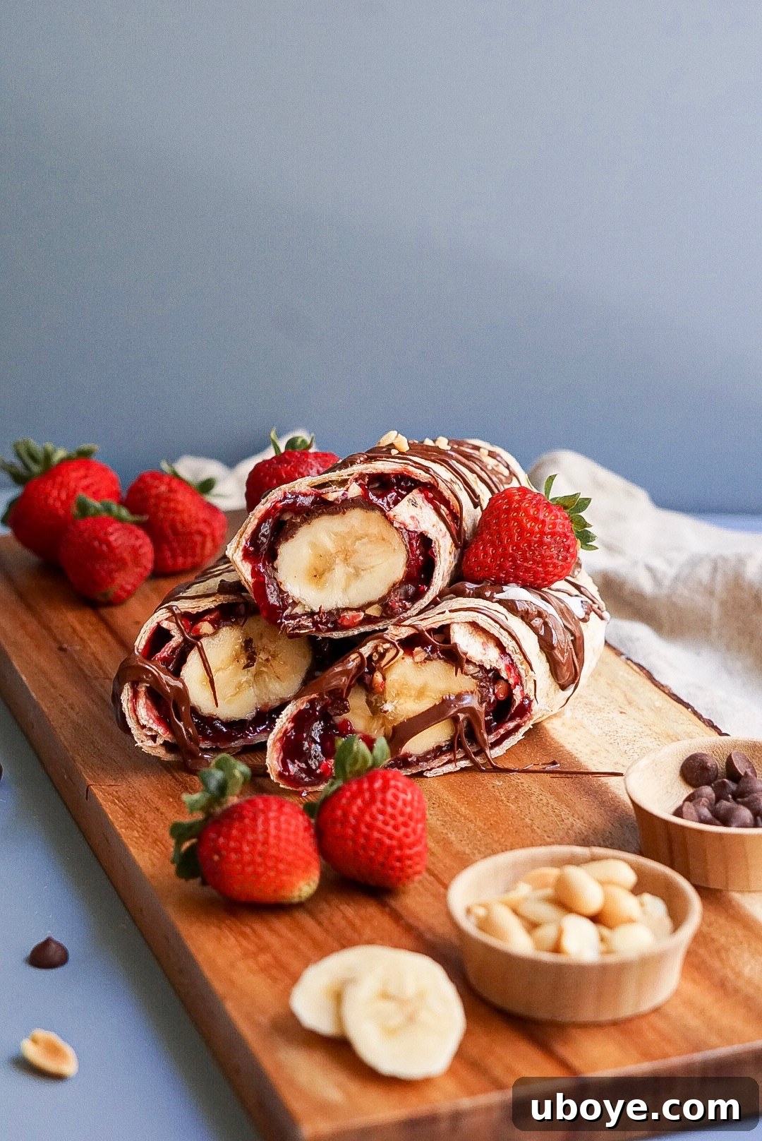 Banana Split Swirls 4 A perfectly sliced Vegan Banana Split Roll-Up, showcasing the distinct layers of banana, chocolate, peanuts, and raspberry jam.