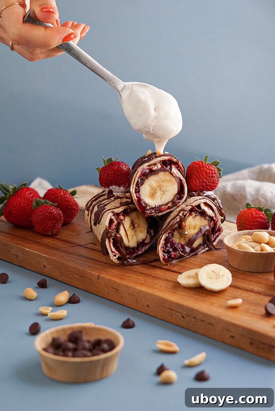 Banana Split Swirls 5 An inviting plate displaying several Vegan Banana Split Roll-Ups, garnished with vegan whipped cream and ready to be enjoyed.