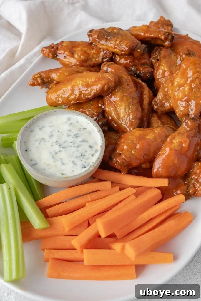Crispy Baked Buffalo Wings 7 Close-up of a single perfectly baked buffalo wing coated in vibrant red sauce