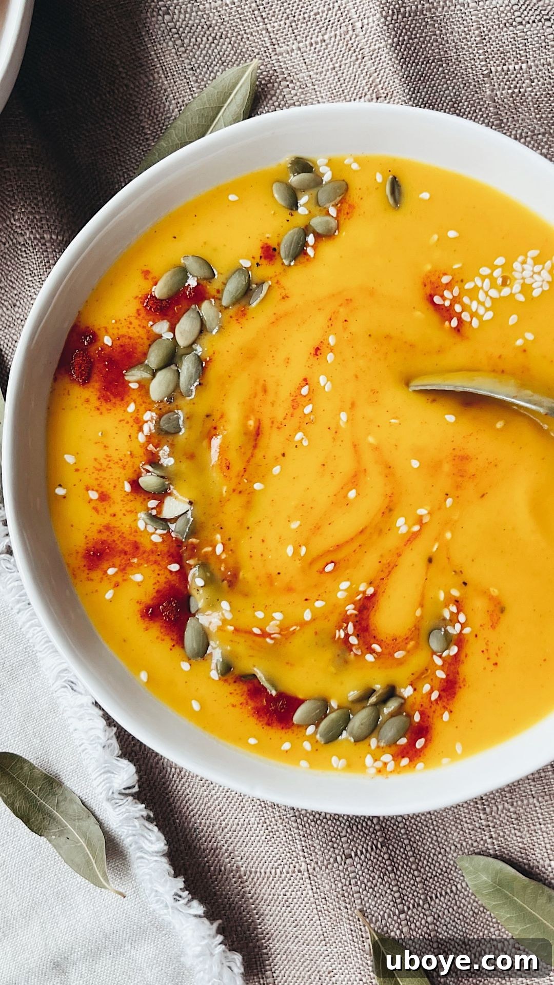 A beautifully garnished bowl of Sheet Pan Butternut Squash Soup ready to be served, highlighting its creamy texture and vibrant color.