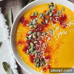 Close-up of a rustic white bowl filled with creamy Sheet Pan Butternut Squash Soup, topped with fresh herbs, ready to be enjoyed.