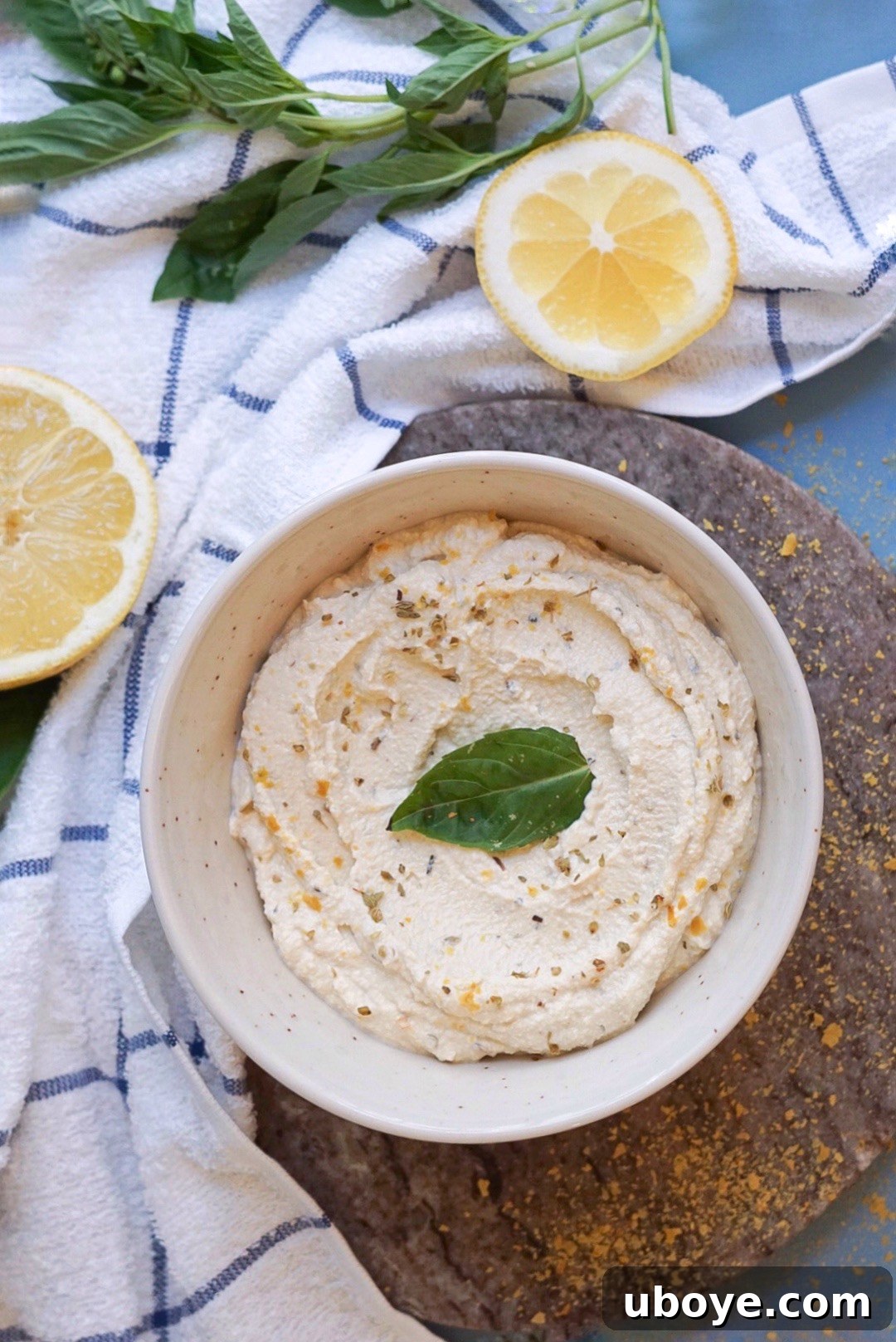 A bowl of creamy homemade vegan ricotta cheese garnished with fresh herbs, ready to be enjoyed