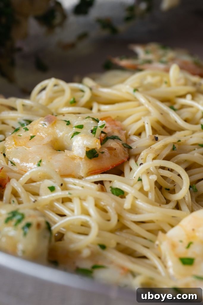 Fresh prawns, herbs, and lemon slices on a wooden cutting board