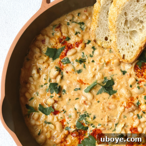 A bowl of Creamy Italian White Beans, garnished with fresh herbs.