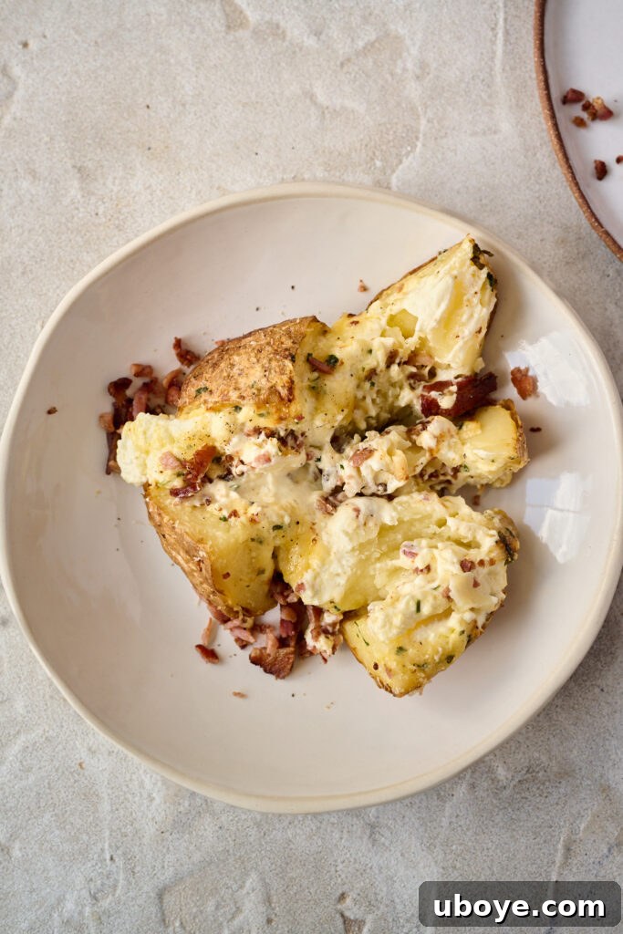 Creamy Garlic Baked Potatoes 8 Stuffed baked potato with melted cheese and herbs, ready to serve