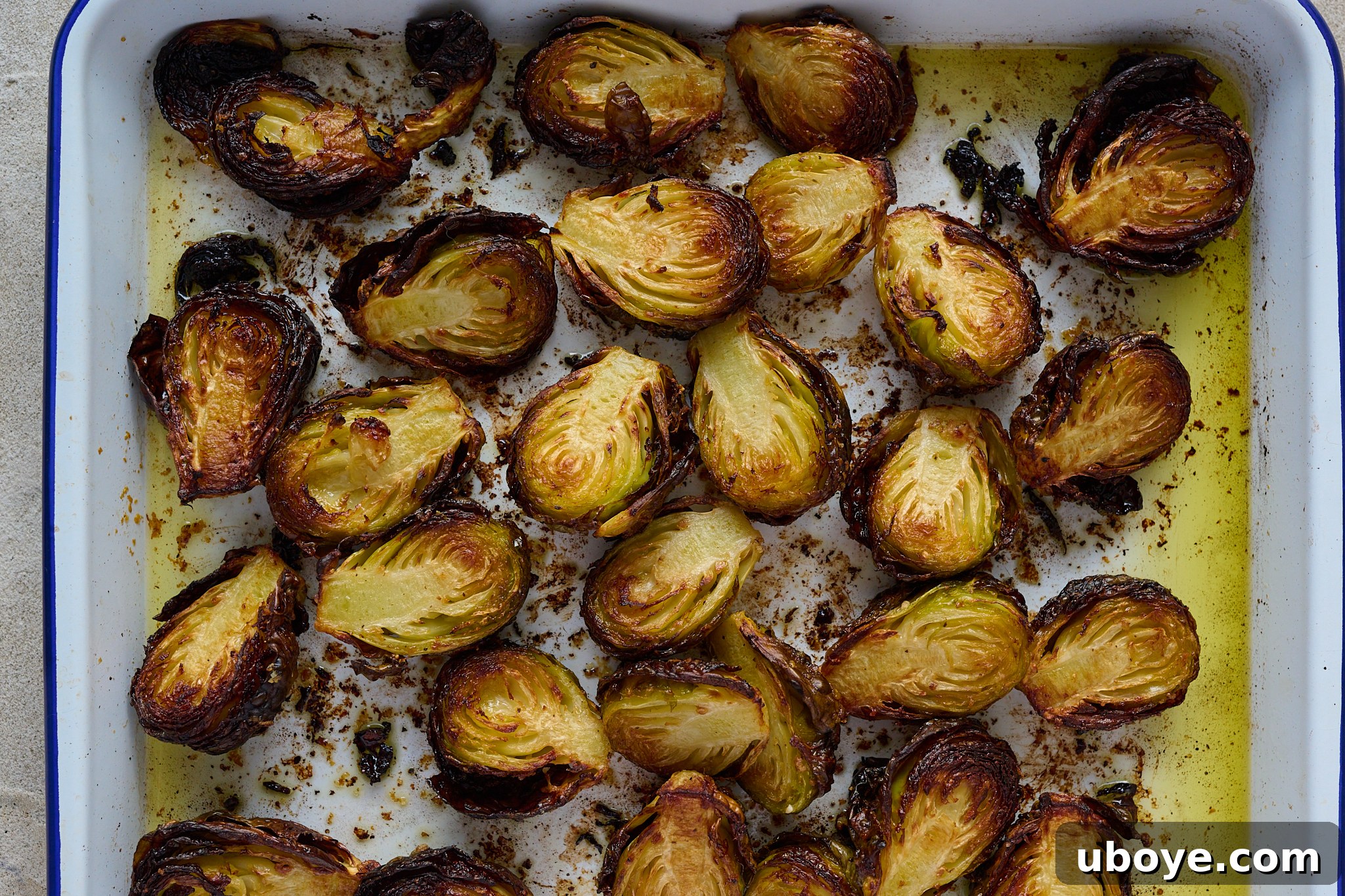 Brussels sprouts are cooked and on roasting tray.