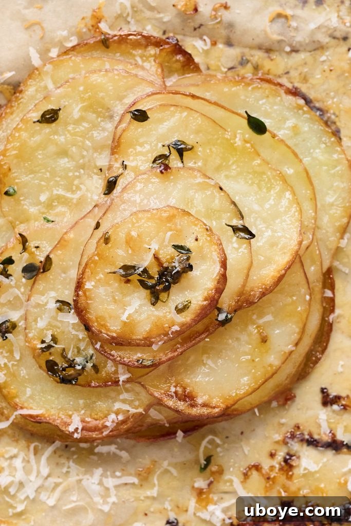 Close-up of baked garlic butter potato stacks, showing the crispy edges
