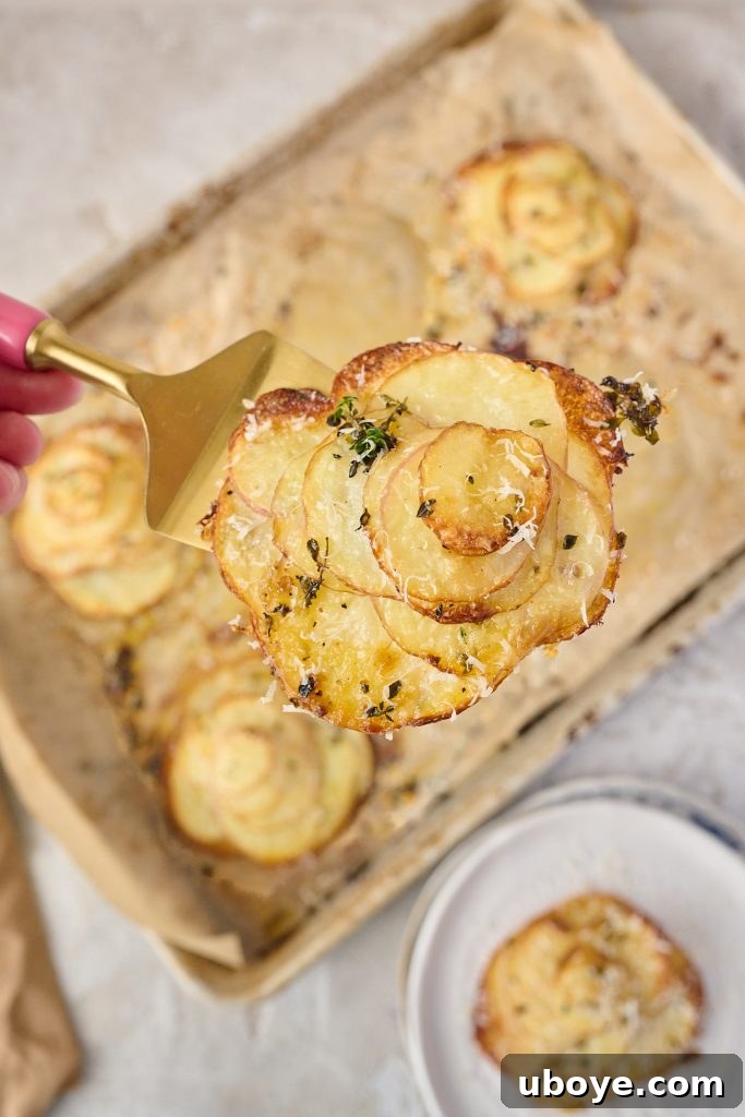 Assembling garlic butter potato stacks on a baking sheet