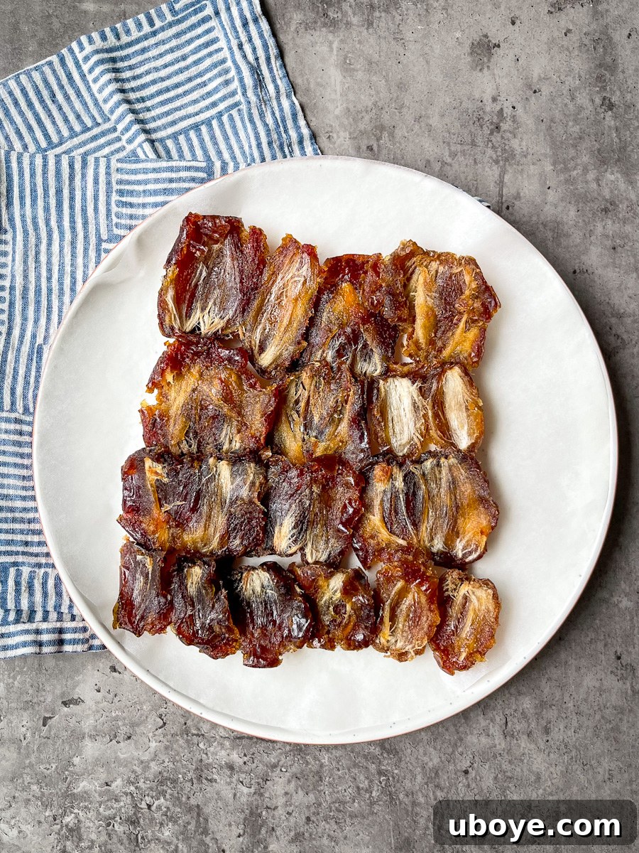 No Bake Date Bark Delight 3 Pitted and flattened Medjool dates arranged on parchment paper