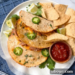 Flavor-Packed Baked Veggie Tacos 9 A single oven-baked veggie taco with salsa and fresh garnishes on a white plate, highlighting its crispy texture.