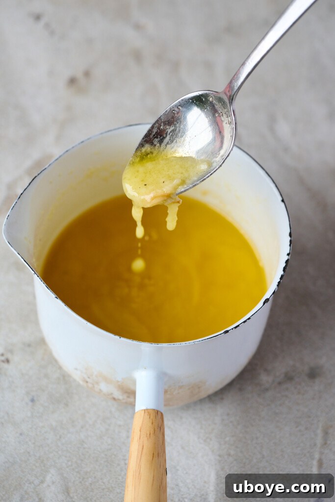 Melted garlic butter in a bowl with a whisk