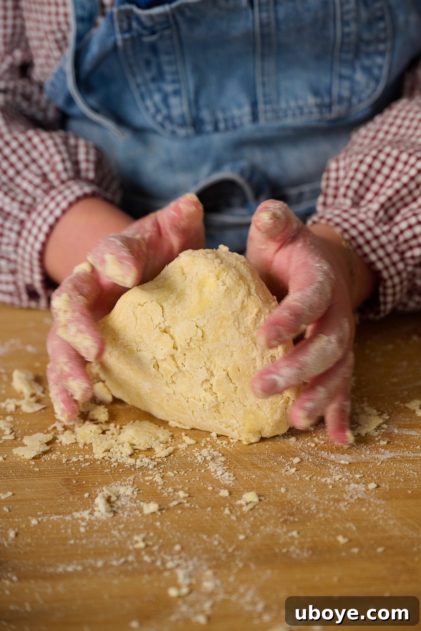 Hearty Chicken, Mushroom and Bacon Pot Pie 5 Ball of puff pastry is on wooden chopping board with hands around it.