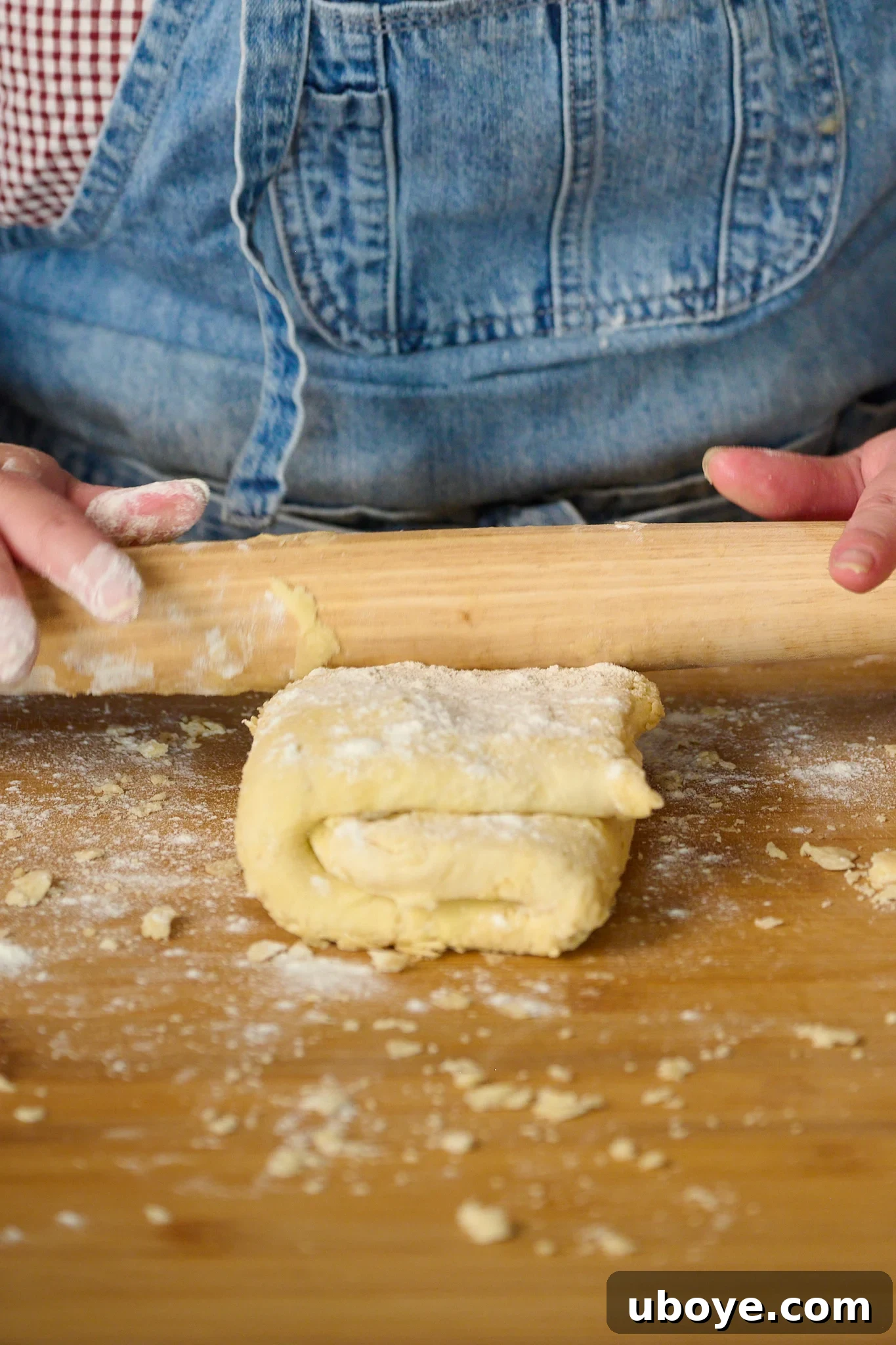Hearty Chicken, Mushroom and Bacon Pot Pie 8 folded puff pastry is being rolled out with rolling pin.