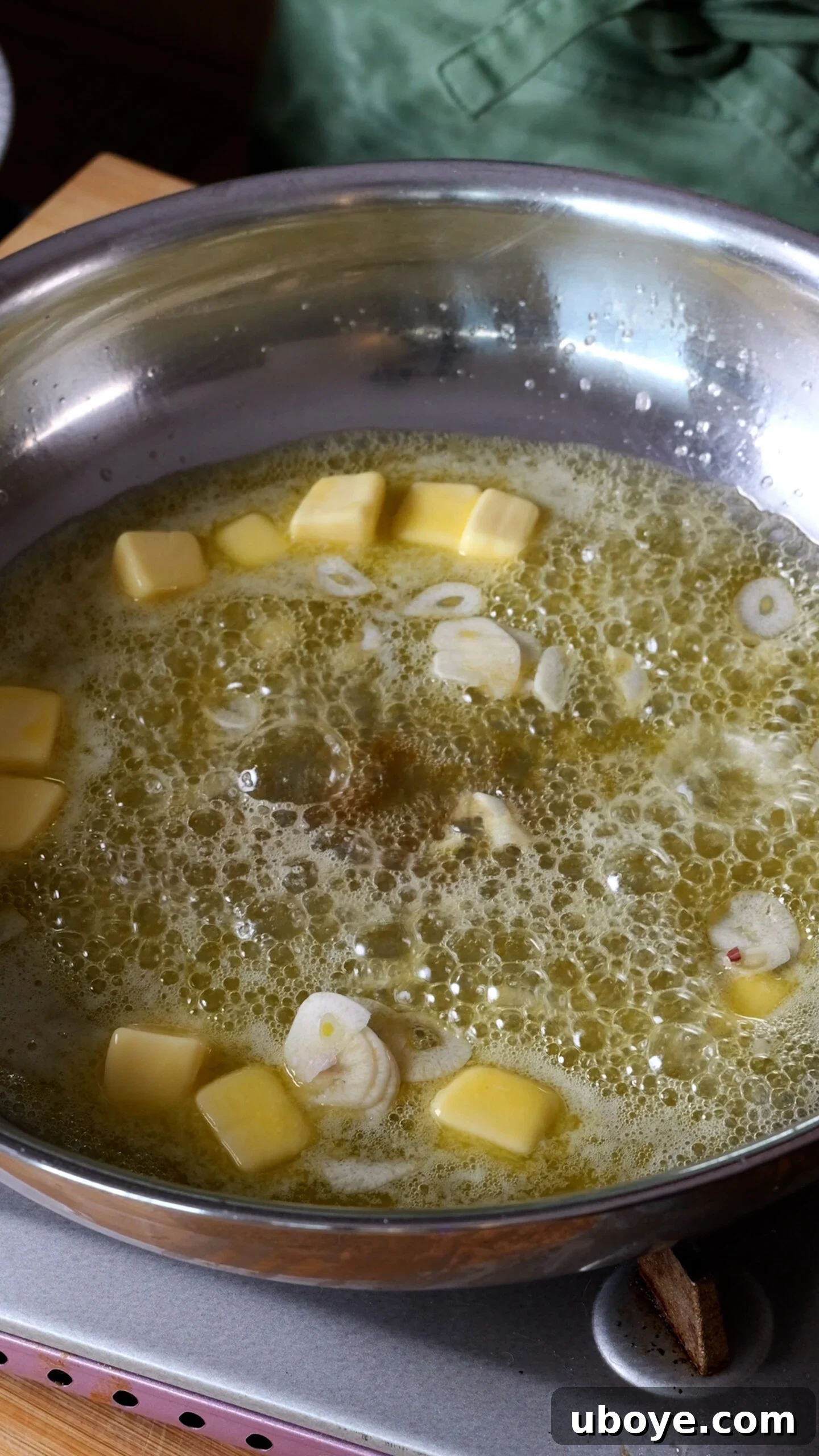 Decadent 10-Minute Anchovy Butter Pasta 5 Butter is melted in a large stainless steel pan on the stove, beginning to sizzle.