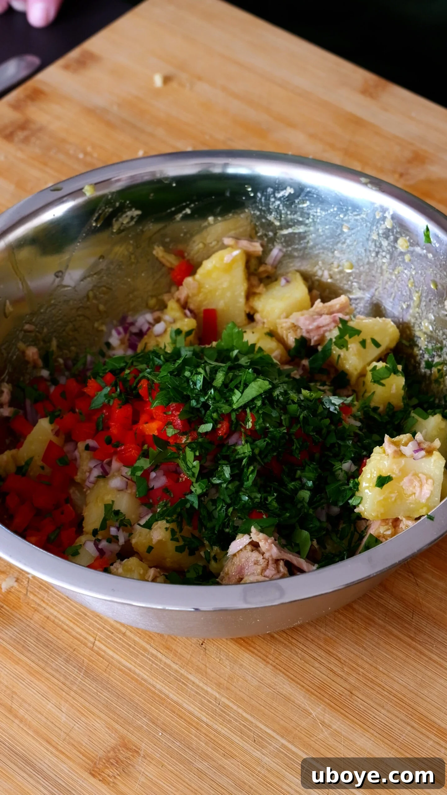 Stainless steel bowl now has capsicum, parsley and red onion in it.