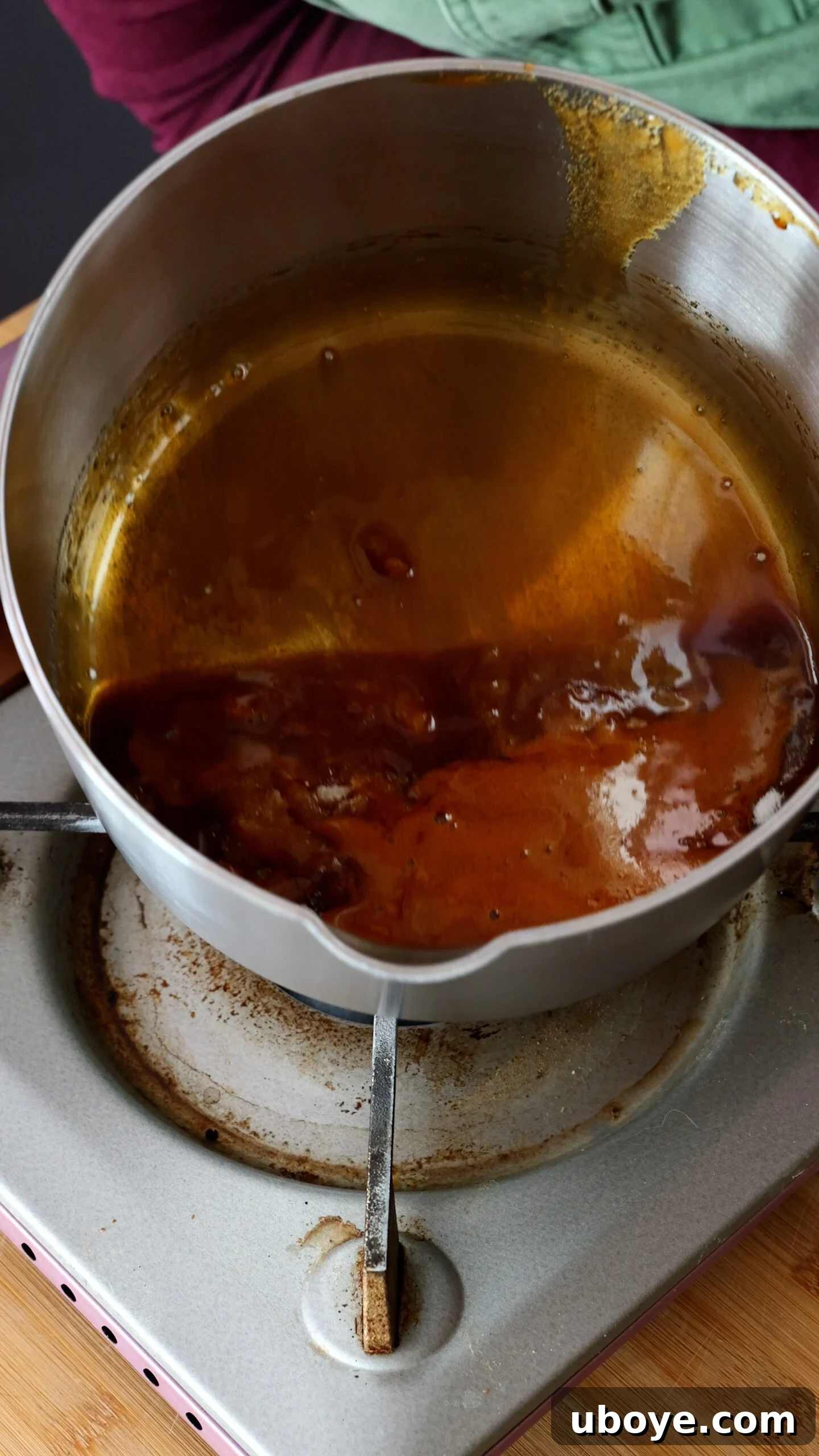 Classic Spanish Flan Recipe: Smooth Caramel Custard You’ll Love 5 Large steel pot has amber coloured caramel in it